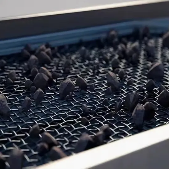 Industrial wire mesh screen sorting granular materials by particle size Industrial wire mesh screen sorting granular materials by particle size