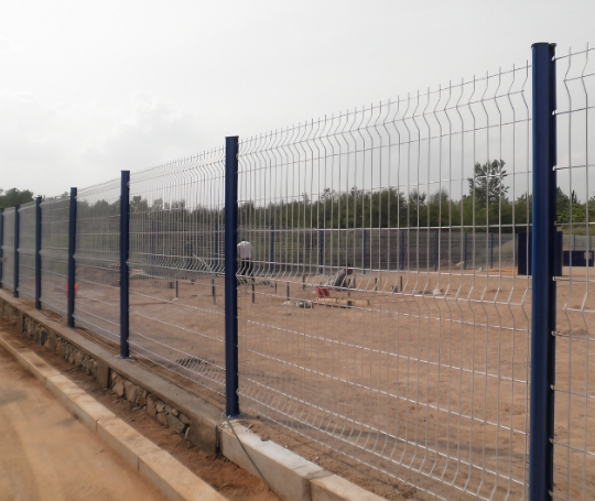 Peach Post Fence set against a backdrop of land Peach Post Fence